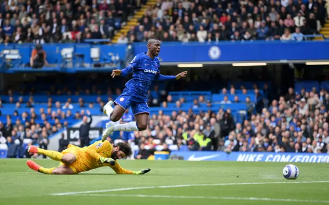 Nicolas Jackson of Chelsea is challenged by Alisson Becker