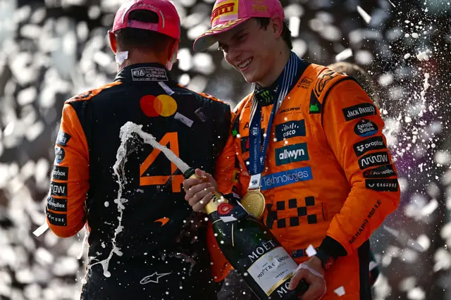 Oscar Piastri sprays champagne