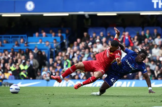 Mohamed Salah (C) is fouled by Chelsea's Belgian midfielder Romeo Lavia