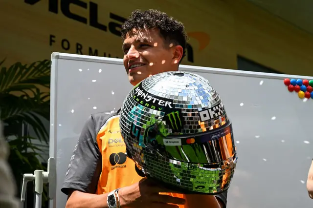 Lando Norris shows off his disco ball helmet