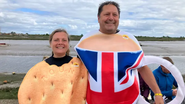 Halstead mayor Andy Munday is dressed like a teacup. He is standing with his wife, Linda Smith, who is dressed as a digestive biscuit.