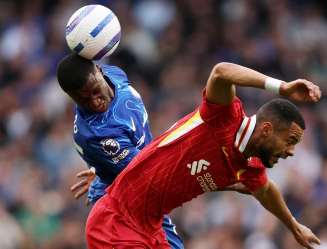 Liverpool's Cody Gakpo in action with Moises Caicedo