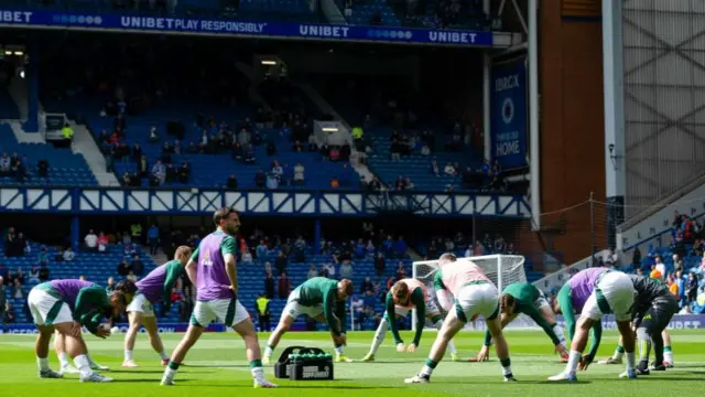 Celtic players warming up at Ibrox