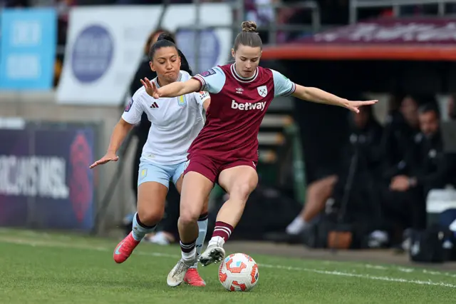 Maz Pacheco of Aston Villa runs with the ball whilst under pressure from Anouk Denton of West Ham United during the Barclays Women's Super League match between West Ham United and Aston Villa at Chigwell Construction Stadium
