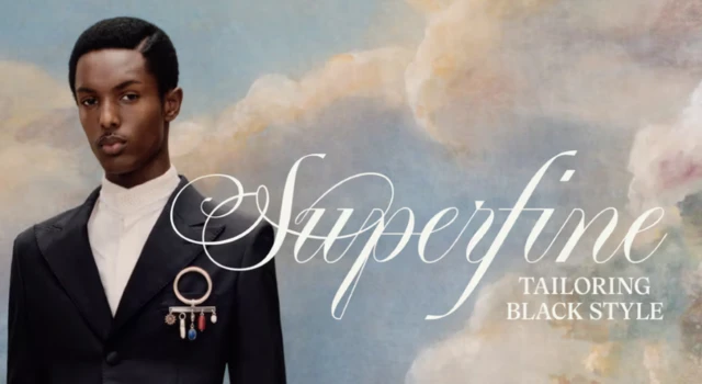 A man wearing a smart black suit and white shirt with a painted background of a blue sky with clouds, covered with text which says: 'Superfine, tailoring black style'.