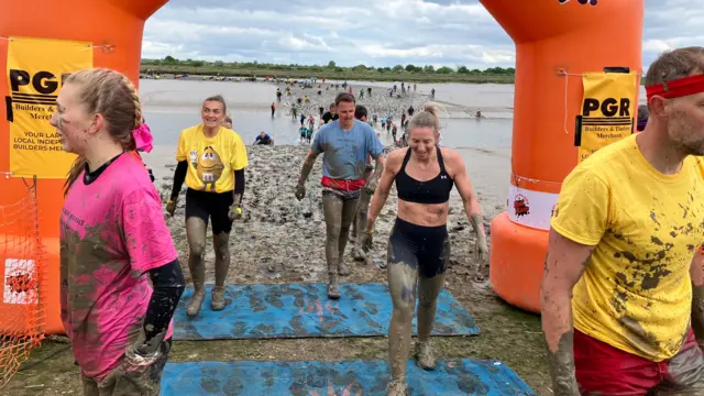 People cross the finish line