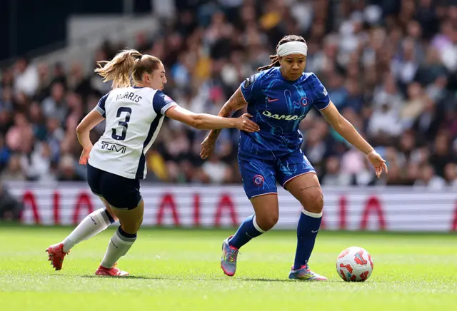 Mia Fishel of Chelsea is challenged by Ella Morris of Tottenham Hotspur during the Barclays Women's Super League match between Tottenham Hotspur and Chelsea at Tottenham Hotspur Stadium on May 04, 2025 in London, England