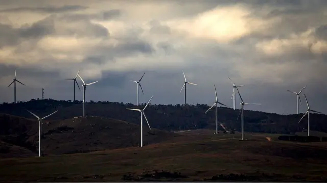 Clouds are seen above power-generating wind turbines at the Capital Wind Farm in NSW