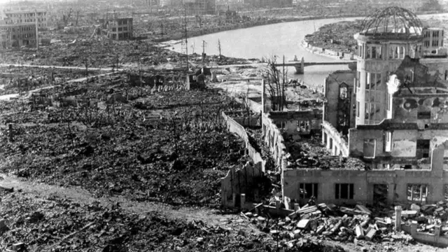 Black and white image shows the rubble of destroyed buildings in Hiroshima