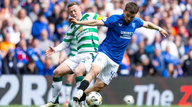 Celtic's Callum McGregor with Rangers' Nico Raskin