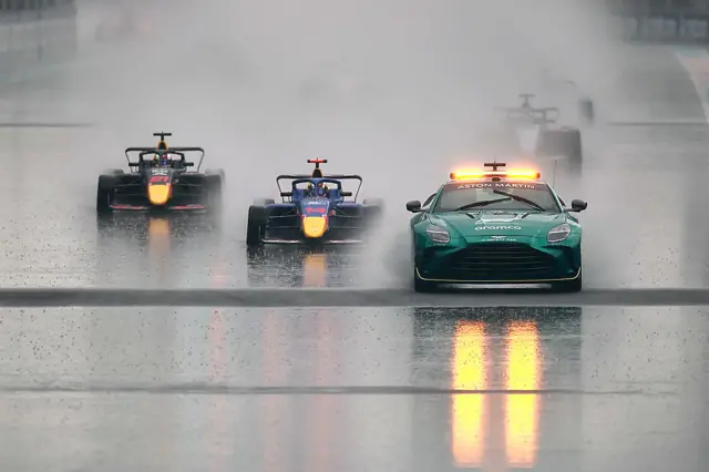 F1 Academy drivers follow the safety car in pouring rain in Miami
