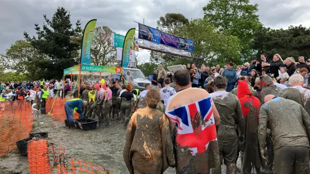 People queue for open shower.