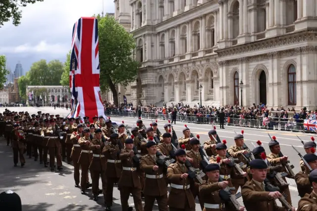 Members of the armed forces march during the military procession