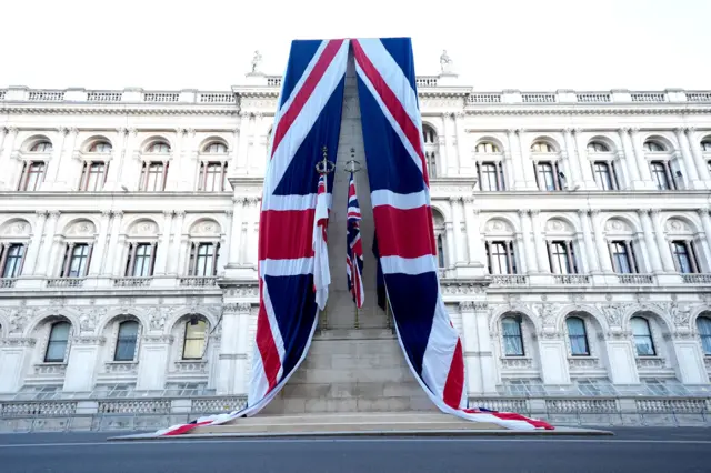 Two union flags are draped over cenotaph on Whitehall
