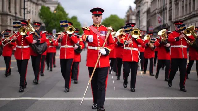 Members of military band march