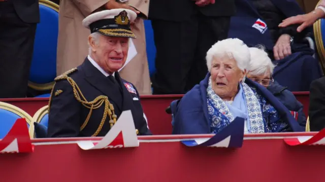 King Charles sat next to Joy Trew in a blanket during the parade