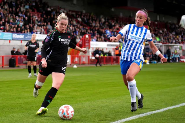 Arsenal's Alessia Russo (left) and Brighton and Hove Albion's Caitlin Hayes battle for the ball
