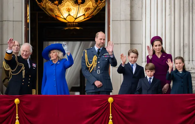 King Charles III, Queen Camilla, Prince William, Prince of Wales, Prince George, Catherine, Princess of Wales, Prince Louis and Princess Charlotte watch the flypast