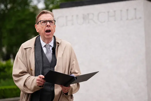 British actor Timothy Spall rehearses for his reading of Winston Churchill's 1945 victory speech, in front of the statue of the war time leader, ahead of the armed forces procession