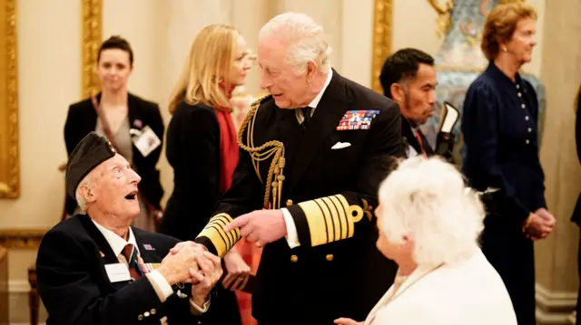 Veteran shakes king's hand