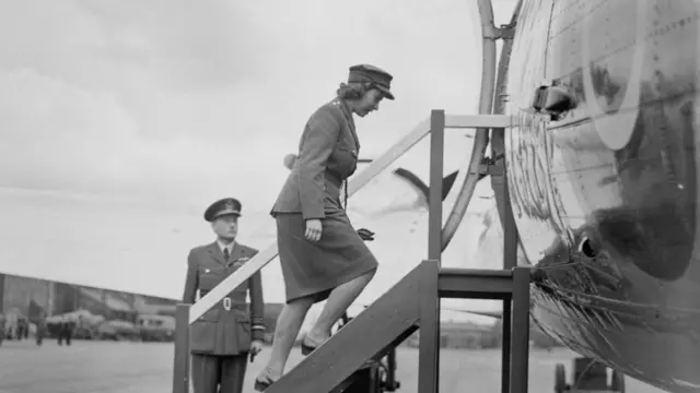 The then-Princess Elizabeth in her ATS uniform boarding a plane in 1945