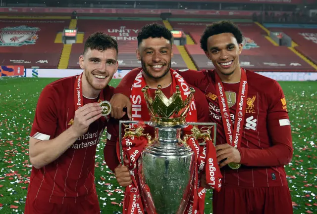 Andy Robertson, Alex Oxlade-Chamberlain and Trent Alexander-Arnold with the Premier League trophy in 2020