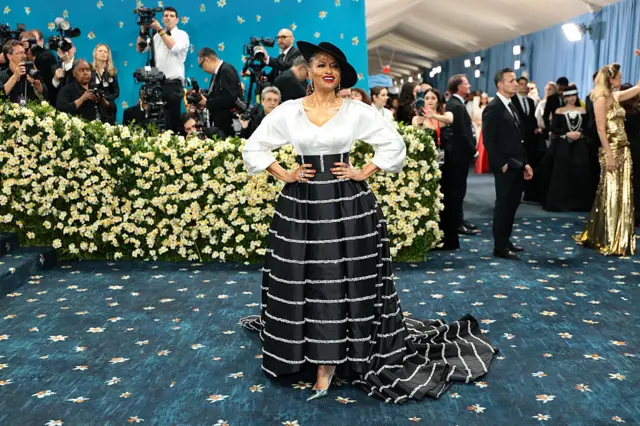 Ava DuVernay attends the 2025 Met Gala in a black and white gown. She is wearing a black fascinator.