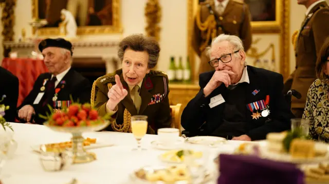 Princess Anne speaks while sitting at table
