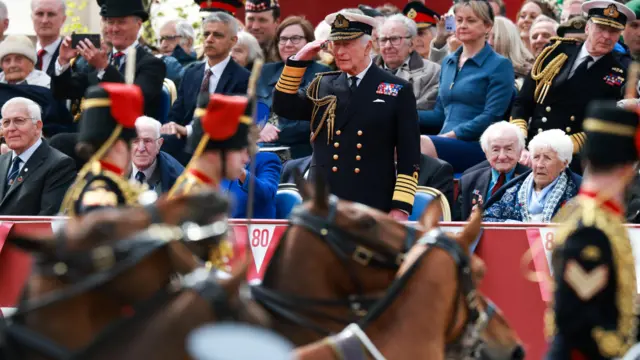 Charles salutes military