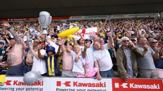 Leeds fans in football stand cheering
