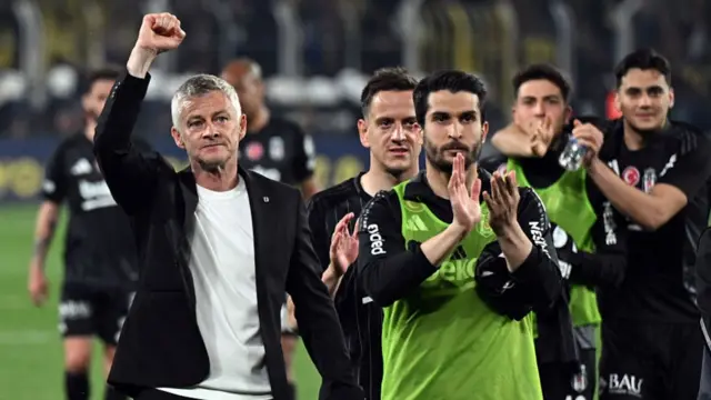 Manager Ole Gunnar Solskjaer salutes the Besiktas fans after his team win at Fenerbahce