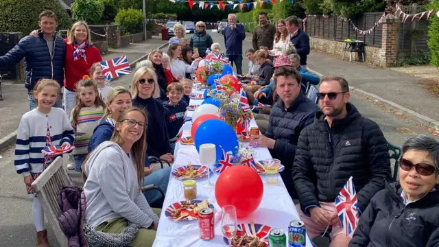 People at street party table