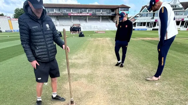 Nick Pepper tamping down the bowlers footmarks ready for day 4
