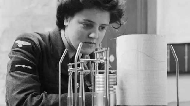 Leading Aircraftwoman M Wishart, a meteorological clerk, takes a weather reading from a thermohygrograph at RAF Pitreavie Castle, Dunfermline
