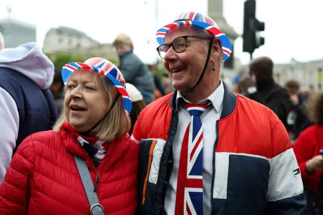 People gather to watch the armed forces and veterans' parade