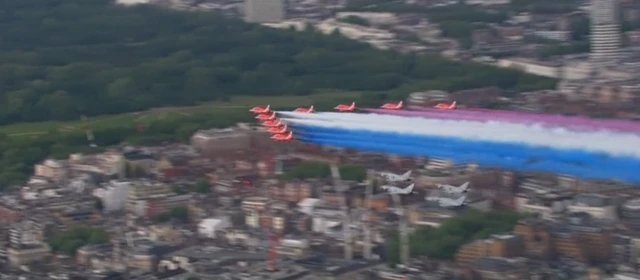 The Red Arrows left trails of coloured blue, red and white smoke above the skies of London