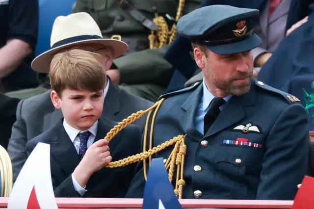 Prince Louis pulls at Prince Williams uniform