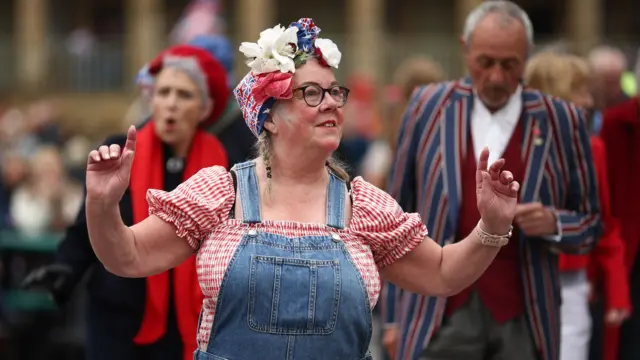 Woman dancing wearing dungarees
