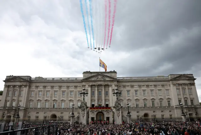 The Royal Air Force Aerobatic Team Red Arrows fly past Buckingham Palace