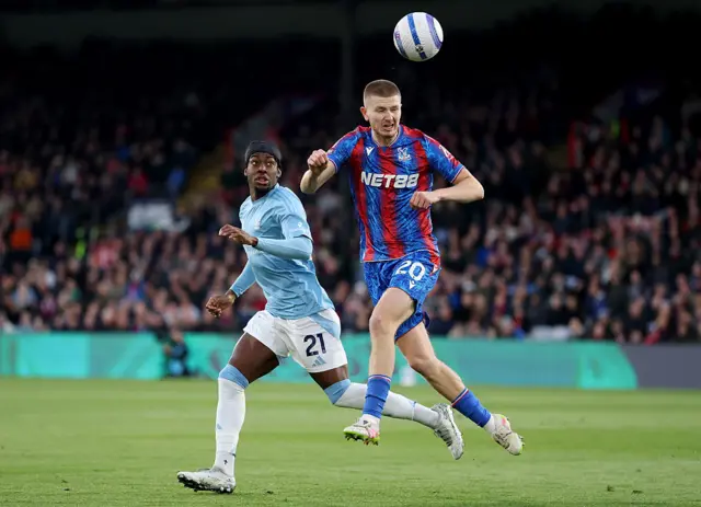 Adam Wharton of Crystal Palace heads the ball under pressure from Anthony Elanga of Nottingham Forest during the Premier League match between Crystal Palace FC and Nottingham Forest FC at Selhurst Park