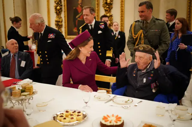 Catherine laughs as she speaks to veteran sat at dining table