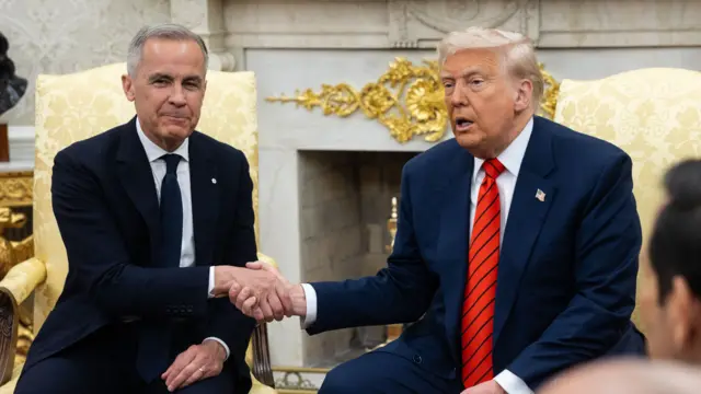 Carney smiles as he shakes Trump's hand - the pair are sitting in the White House