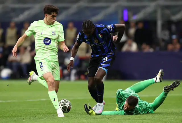 Wojciech Szczesny of FC Barcelona makes a save as he challenges at the feet of Marcus Thuram