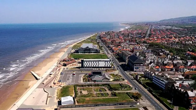 The beach brings visitors to Rhyl
