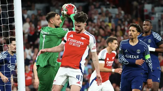 Gianluigi Donnarumma of Paris Saint-Germain stops the ball over Declan Rice