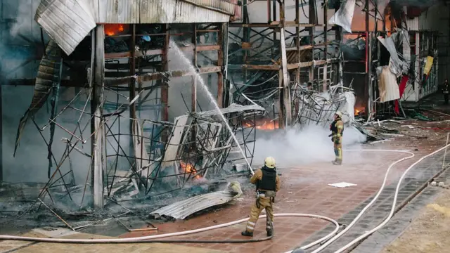 Firefighters extinguish the flames, following a Russian attack with 20 shahed Drones, in Kharkiv