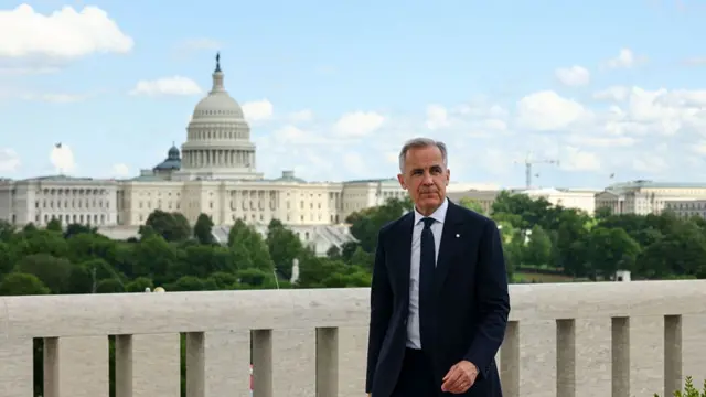 Mark Carney walks away after his press conference. The dome of the US capitol is behind him.