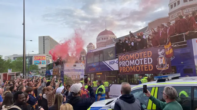 Bus with Bradford Live in background with players on it celebrating