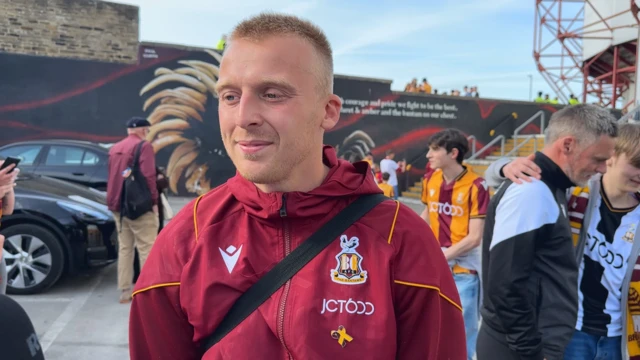 George Lapslie in his Bradford City tracksuit speaking to a BBC reporter