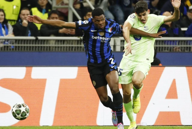Inter Milan's Denzel Dumfries in action with FC Barcelona's Gerard Martin